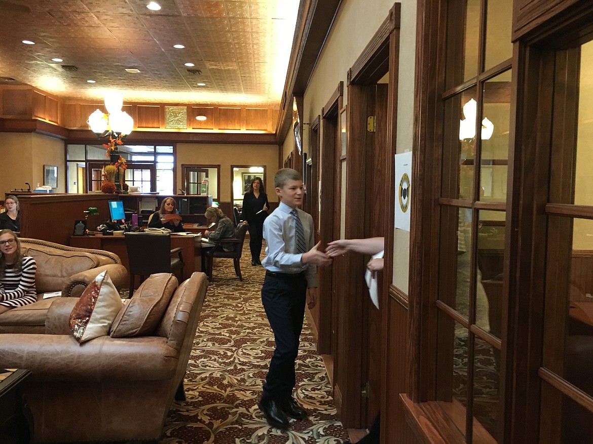 Jackson Heino prepares to shake the hand of an interviewer at Valley Bank during Round 2 competition of The Amazing Shake.