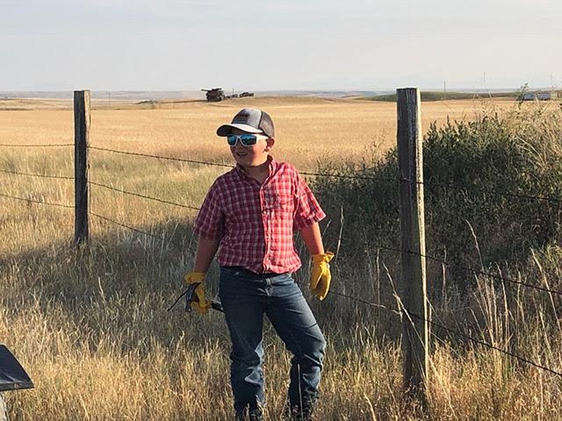 WILL COX, 9, working on a ranch in the Big Sandy area earlier this year. Will is the youngest of four Cox boys who, along with their dad and grandad, have worked to help a local rancher with the many chores that are necessary to keep things running smoothly. In turn, the rancher grants access to the family to hunt. The results are shown in the related photos. (Courtesy photo)