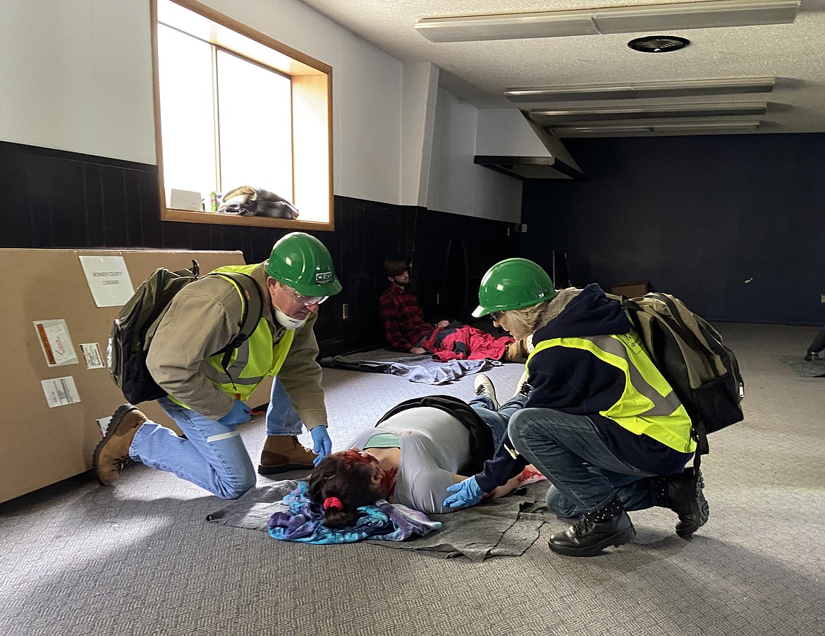 (Photo by CAROLINE LOBSINGER)
Certified Emergency Response Team members give first aid to a &#147;victim&#148; of a high-speed windstorm. The mock disaster was held as part of their finals on Saturday.