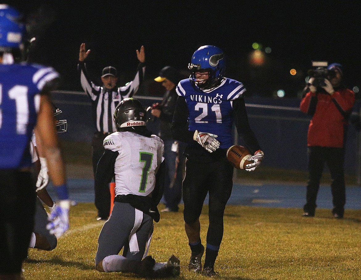 Coeur d&#146;Alene High wide receiver Colbey Nosworthy (21) walks past Mountain View defender Jarin Baroli after a touchdown.