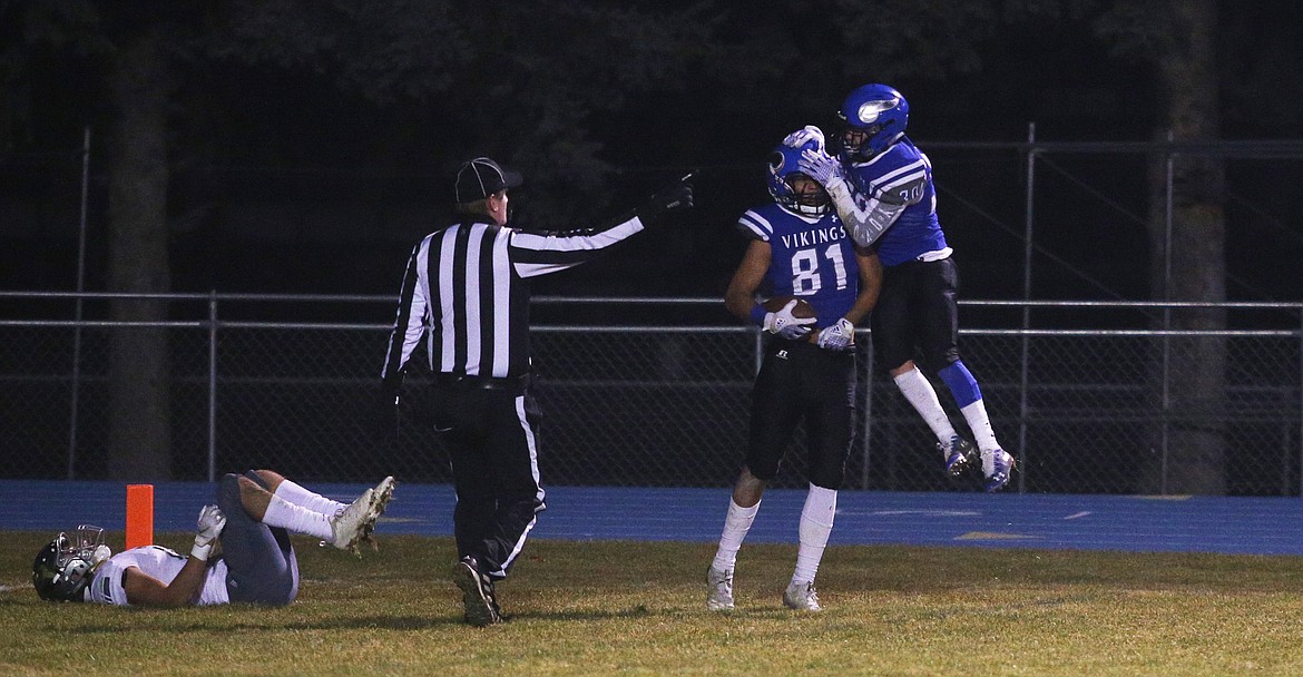 Coeur d&#146;Alene wide receiver Devon Johnson (81) and Hunter Schueller celebrate Johnson&#146;s interception during Friday night&#146;s quarterfinal game against Mountain View.