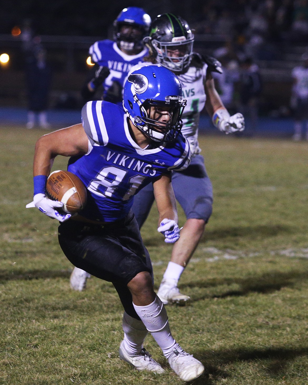 Coeur dAlene wide receiver Devon Johnson runs upfield after the catch during Friday nights quarterfinal game against Mountain View.