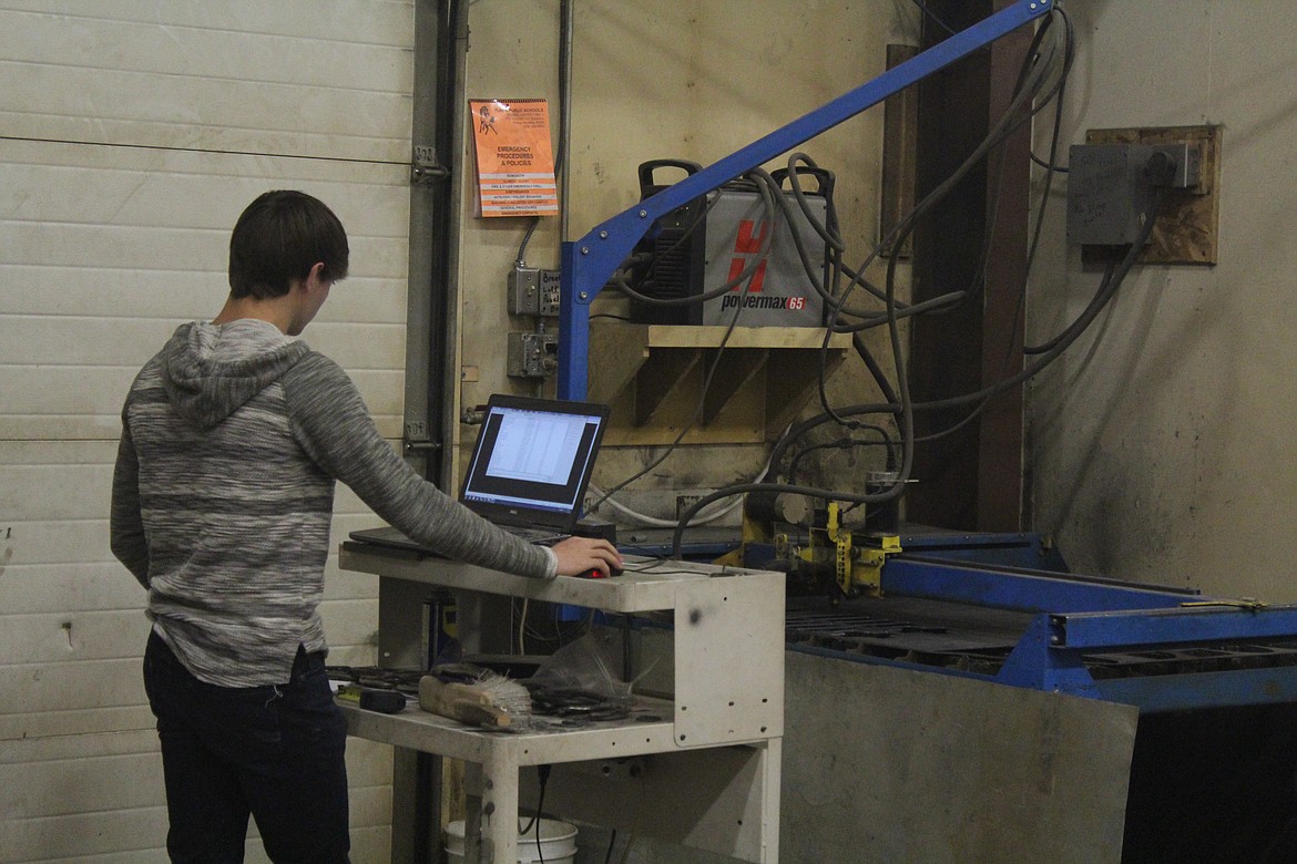 TREYDON BROUILLETTE works the plasma cutting machine to cut out some parts for a truck bumper. He is 18 and a senior at Plains High. Treydon is planning on using his metal work skills after high school, possibly opening up a shop with his brother. (John Dowd/Clark Fork Valley Press)