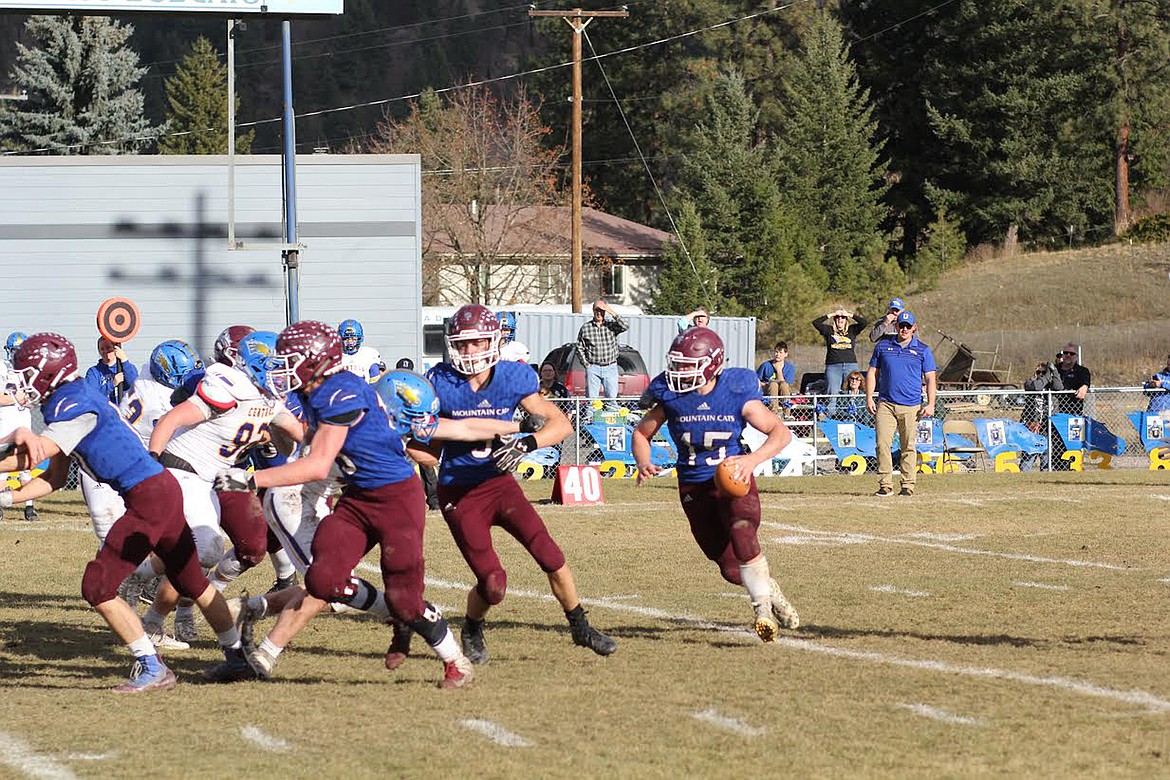 Clark Fork Mountain Cats running back Trey Green (15), who scored three running touchdowns in the game, runs the ball out of the wildcat formation against Great Falls Central Saturday in the state semifinals. (Chuck Bandel/Mineral Independent)