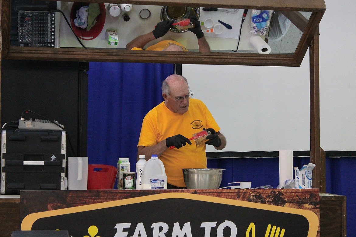 Rachal Pinkerton/Sun Tribune
Steve Dulude get honey out of a jar during a homemade ice cream demonstration at the Central Washington State Fair earlier in the fall.