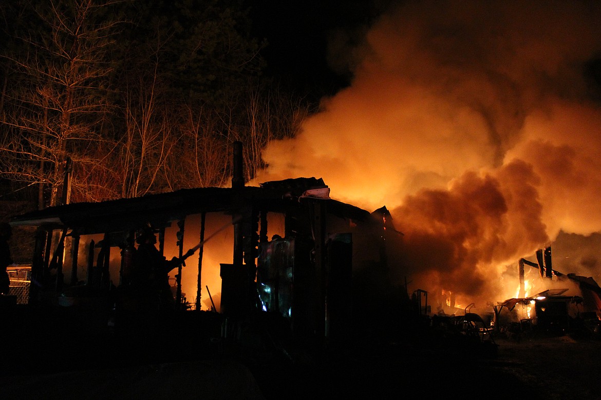 Smoke bellows out of the living enclosure attached to the main living trailer.