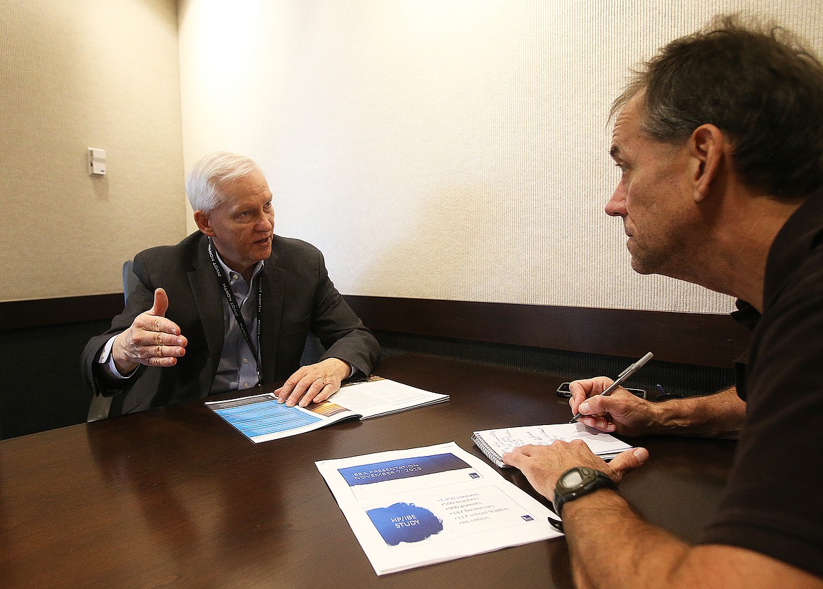 Gramer shares education recommendations with Press reporter Keith Erickson during an interview.