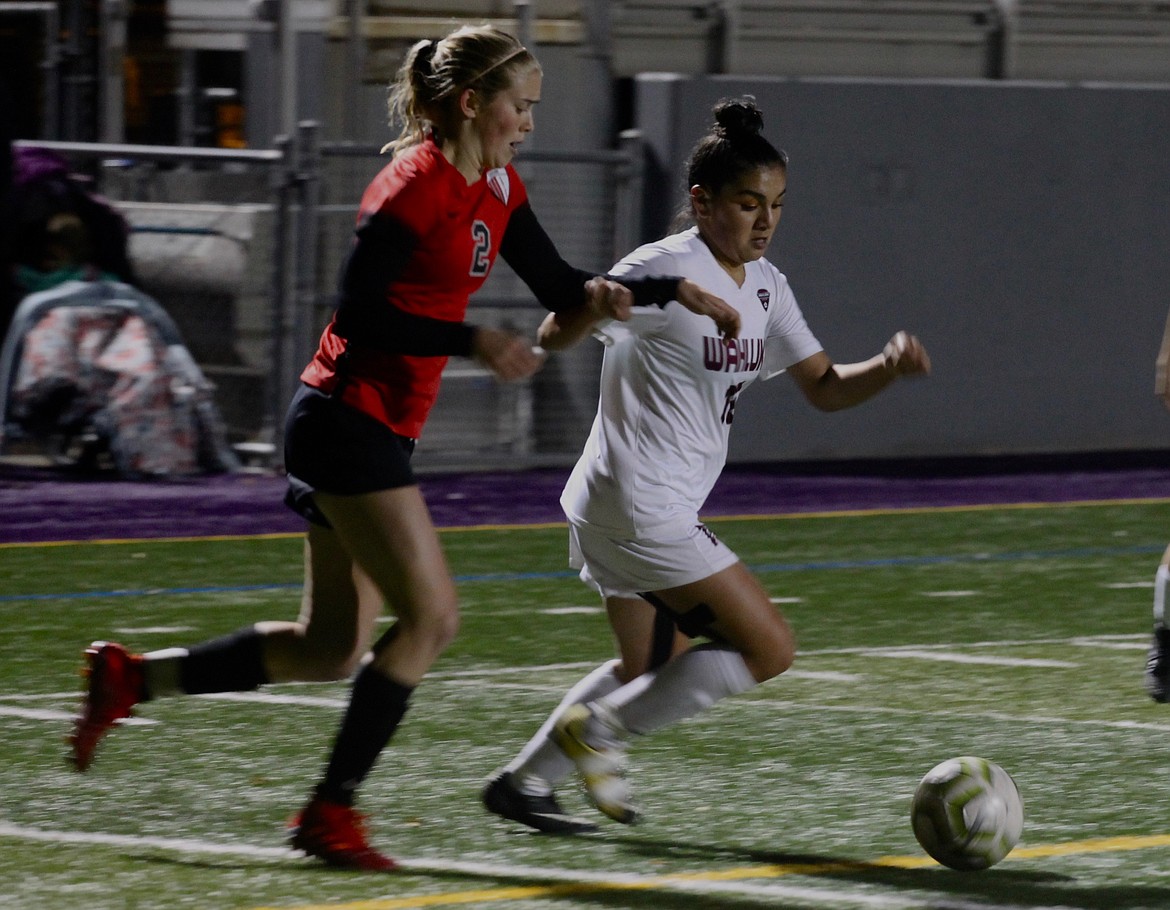 Casey McCarthy/The Sun Tribune Ana Andrade tries to make her way toward the goal in the first half as the Cascade defender fights for possesion on Tuesday night in Wenatchee.