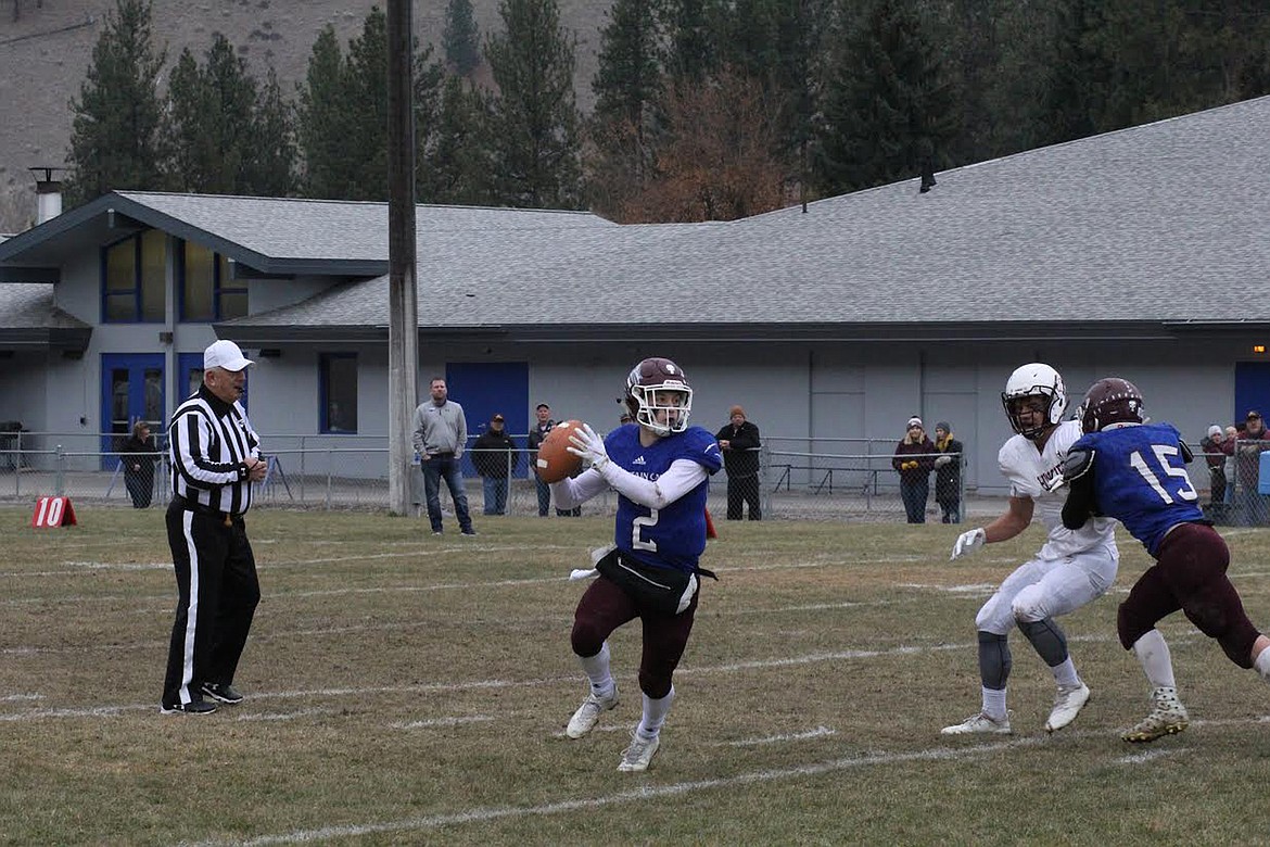 Clark Fork Mountain Cats quarterback Bryan Mask rolls out before making a throw against Belt during Saturday&#146;s game. (Chuck Bandel/Mineral Independent)