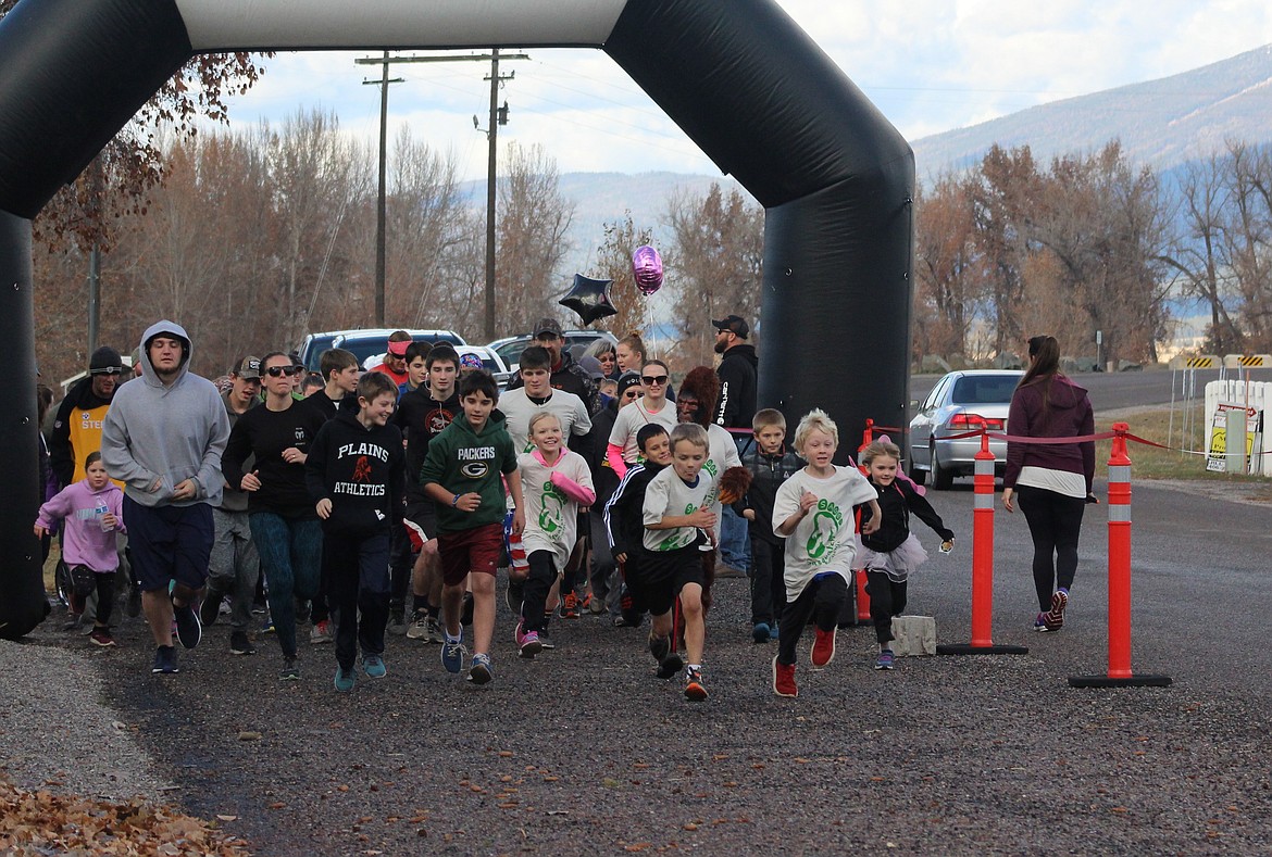 THE RUNNERS taking off, last Sunday, during the fun run fundraiser to benefit the Doble Family. In the center right is Sage Doble, dressed in her sasquatch costume. (John Dowd/Clark Fork Valley Press)