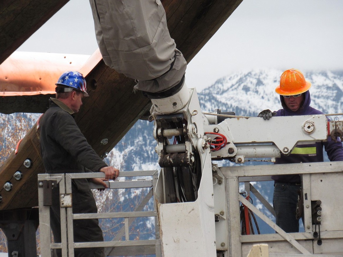 Erecting the new Ronan arch requiring several boom trucks and skilled labor donated by area companies.