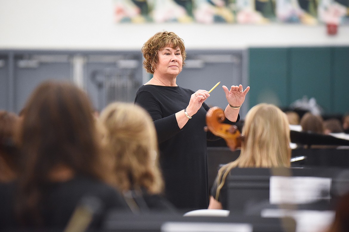 Jenanne Solberg directs the high school orchestra during Monday&#146;s Veterans Day Assembly at Whitefish High School. (Daniel McKay/Whitefish Pilot)