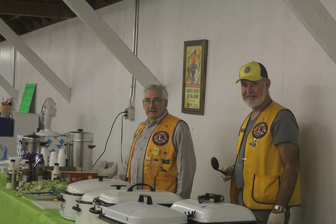 RON ROBINSON, left, and Marv Tanner, right, with the Lions Club helping serve spaghetti during Sunday&#146;s fun run. (John Dowd/Clark Fork Valley Press)