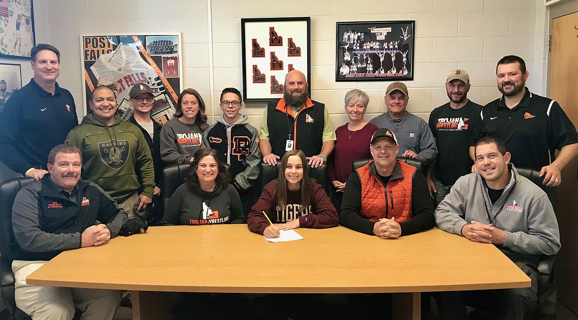 Courtesy photo
Post Falls High senior Brelane Huber recently signed a letter of intent to wrestle at NAIA Campbellsville (Ky.) University. Seated from left are Dave Herndon, Melissa Huber, Brelane Huber, Brian Huber and Luke Roberts; and standing from left, Craig Christensen, Post Falls High athletic director; Abel De La Rosa, Brandon Mason, Molly Mason, Braxton Mason; Pete Reardon, Post Falls High head wrestling coach; Debbie Montgomery, John Montgomery, Lonnie Lovett and Jeremy Zender.