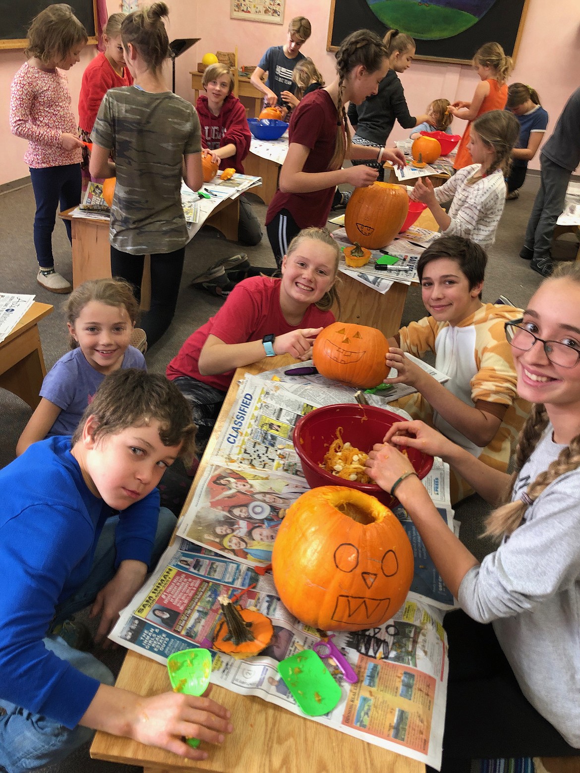 (Photo courtesy SANDPOINT WALDORF SCHOOL)Sandpoint Waldorf School students take a break in their creation of jack-o'-lantern to pose for the camera.