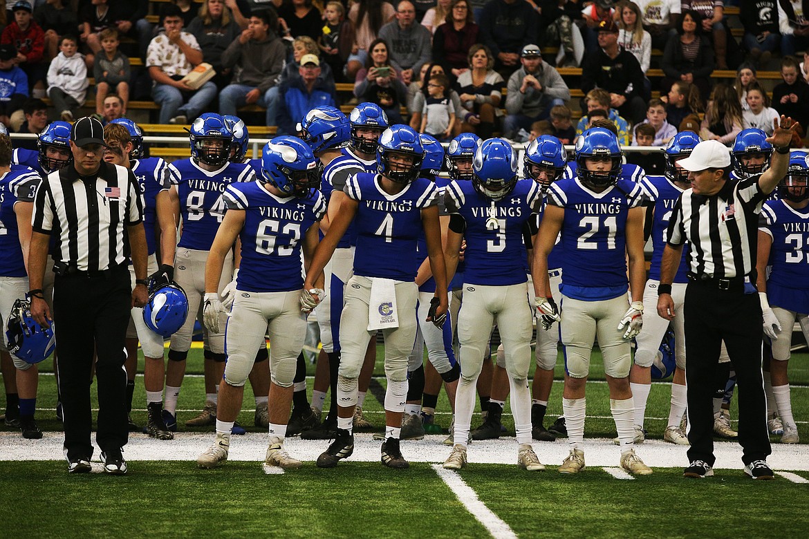 Jack Courtney (63), Jack Prka (4), Jake Brown (3), and Colbey Nosworthy head onto the field for the coin toss before the start of the state 5A championship game.