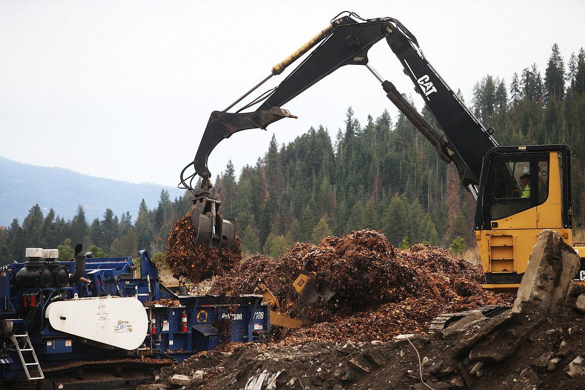 Leaves are dropped into a composter Monday off Seltice Way. Coeur d&#146;Alene&#146;s leaf pickup program began Nov. 12 and ends next week. (LOREN BENOIT/Press)