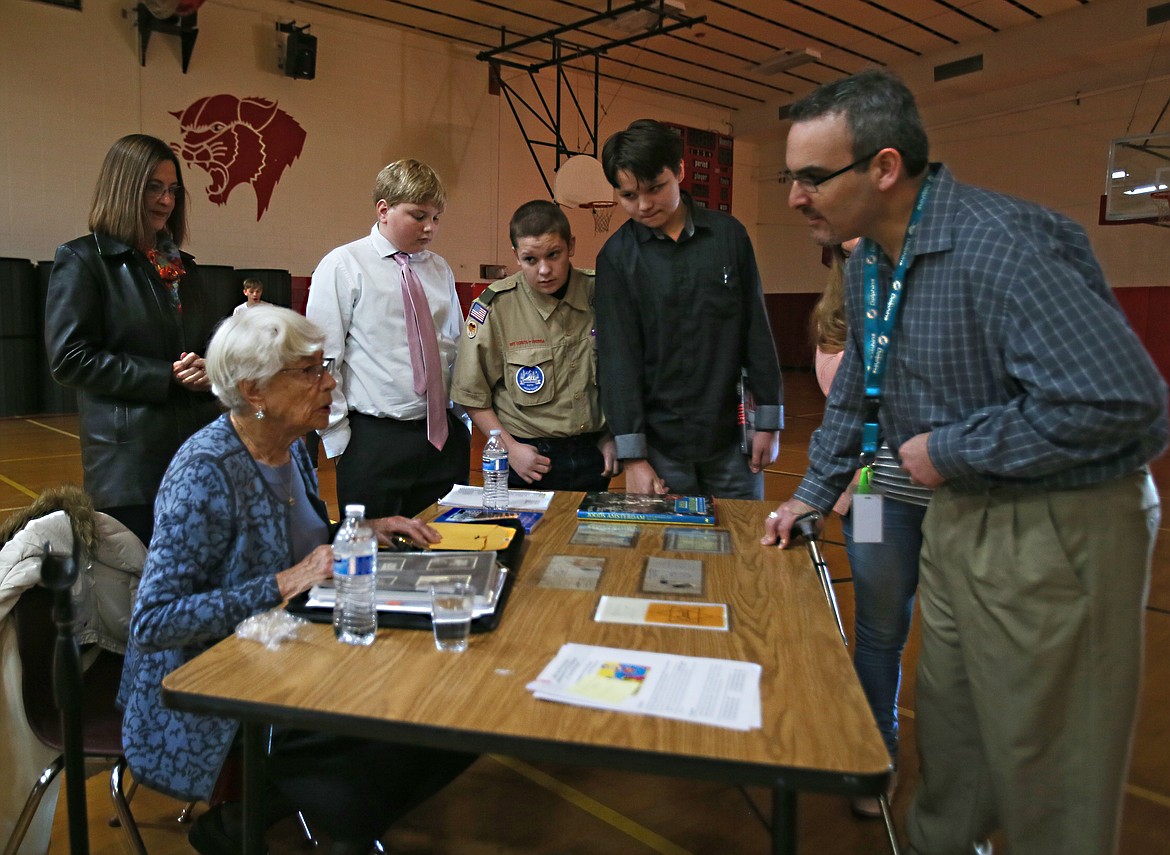 DEVIN WEEKS/Press
Canfield Middle School volunteer Morgan Woodman asks Holocaust survivor Carla Peperzak a few questions following her presentation Thursday. Also pictured, behind Peperzak, from left: Peperzak&#146;s daughter, Marian Cummings, and eighth-graders Erik Wise, Vance Gass and Colby Strong.