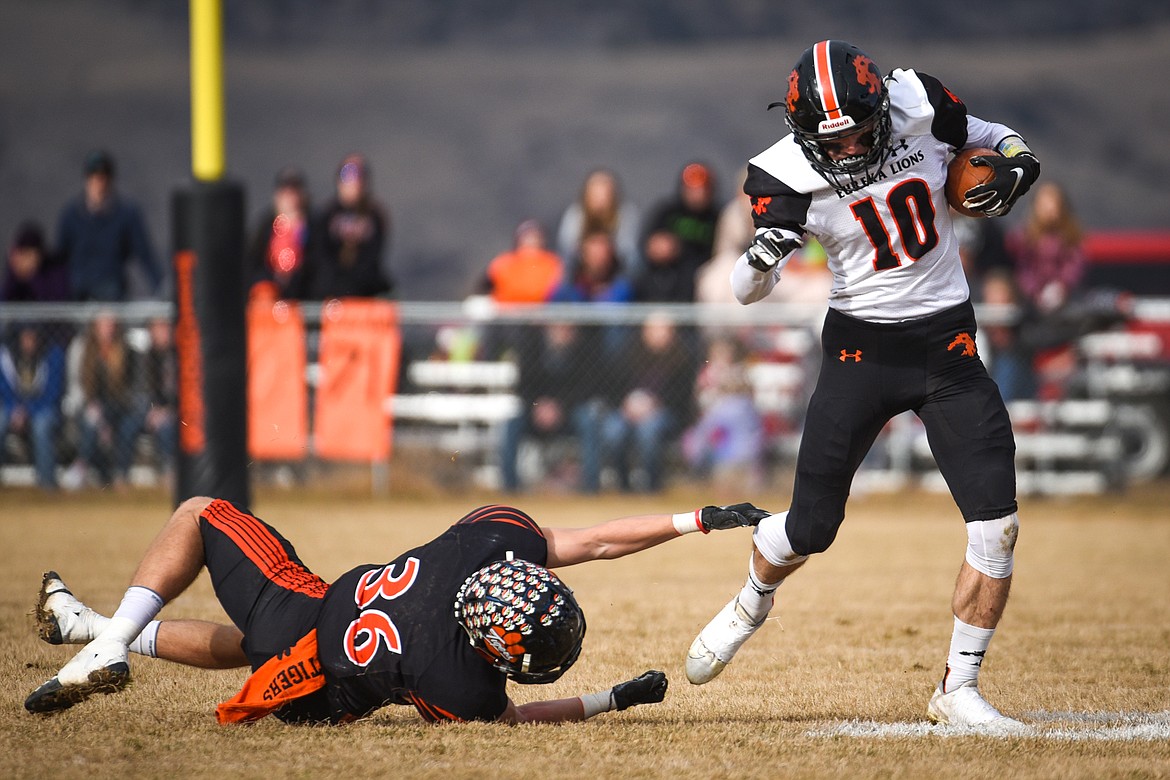 Eureka wide receiver Austin Sartori (10) breaks a tackle by Manhattan defensive back Kyle Hotvedt (36) on an end-around in the Class B State Championship in Manhattan on Saturday. Eureka defeated Manhattan, 20-6. (Casey Kreider/Daily Inter Lake)