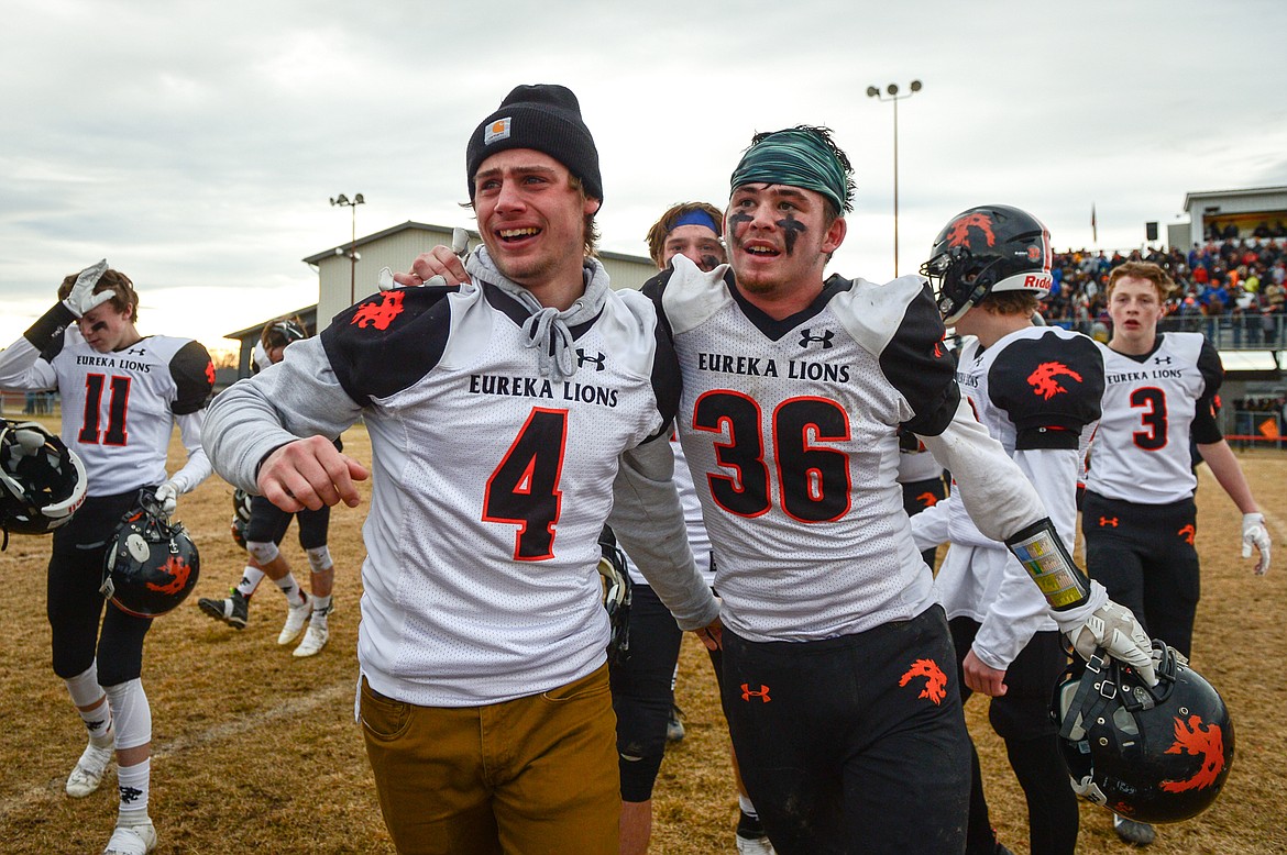 Eureka's Chet McCully (4) and Chance Muller (36) celebrate after the Lions' 20-6 victory over Manhattan in the Class B State Championship in Manhattan on Saturday. (Casey Kreider/Daily Inter Lake)