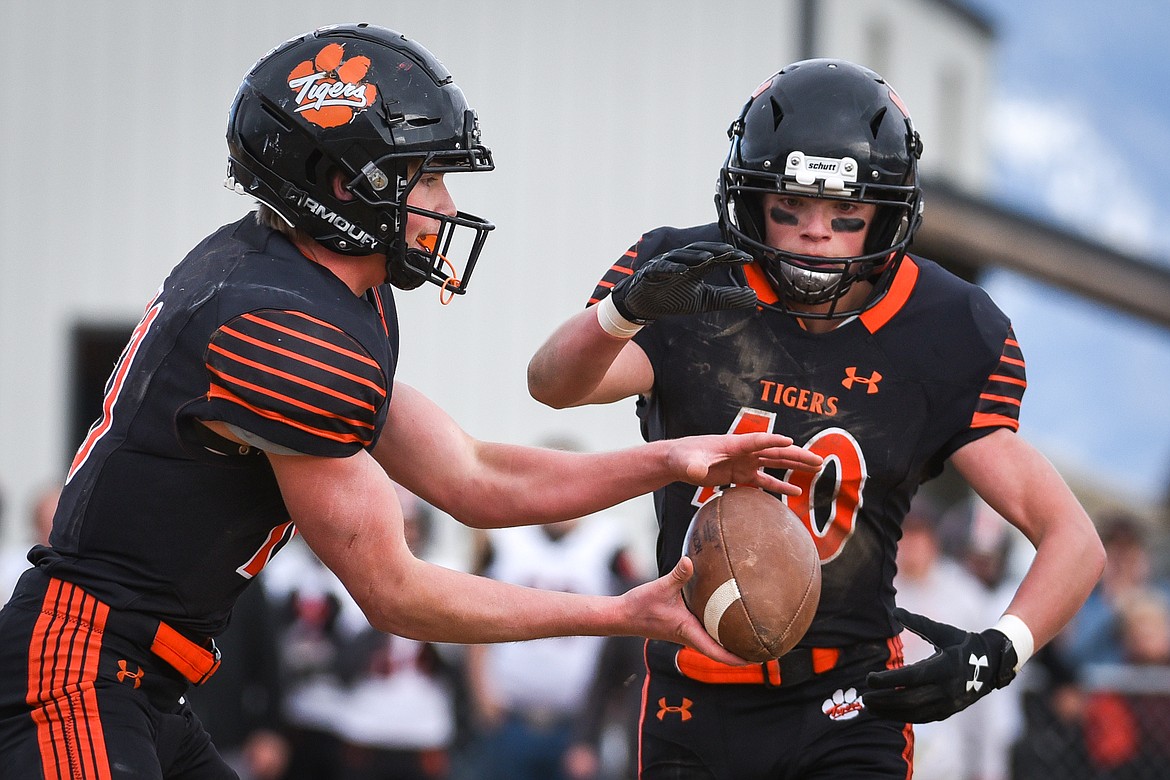 Manhattan quarterback Lane Veltkamp (10) hands off to running back Toby Veltkamp (40) in the Class B State Championship against Eureka on Saturday. (Casey Kreider/Daily Inter Lake)