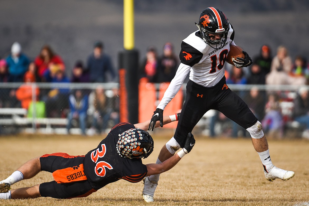 Eureka wide receiver Austin Sartori (10) breaks a tackle by Manhattan defensive back Kyle Hotvedt (36) on an end-around in the Class B State Championship in Manhattan on Saturday. Eureka defeated Manhattan, 20-6. (Casey Kreider/Daily Inter Lake)