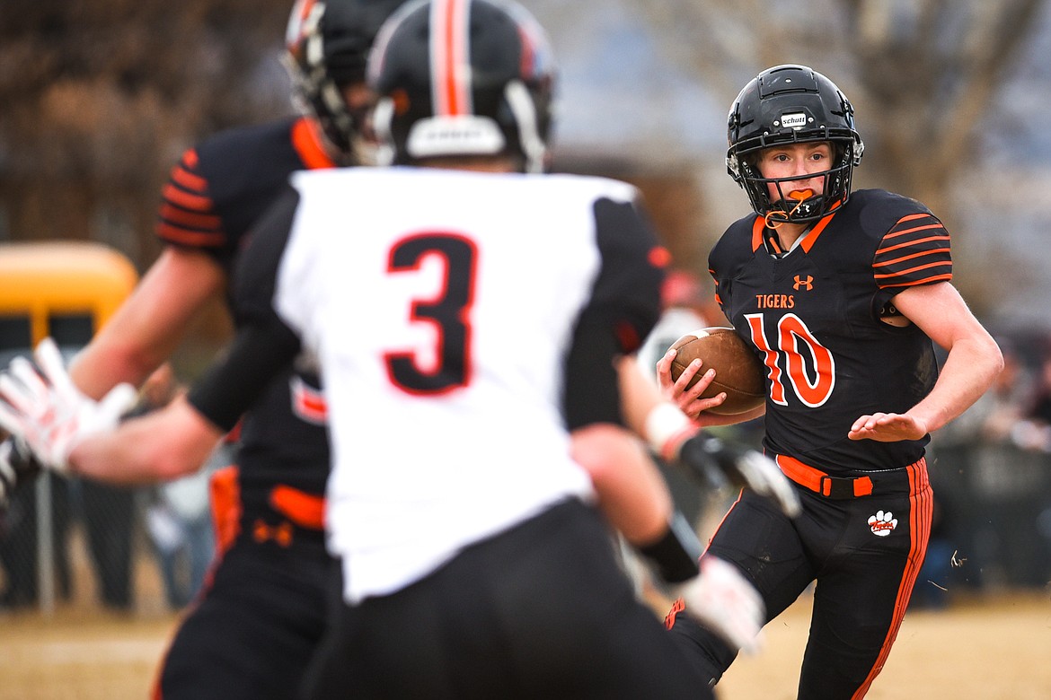 Manhattan quarterback Lane Veltkamp (10) looks for running room in the Class B State Championship against Eureka on Saturday. (Casey Kreider/Daily Inter Lake)