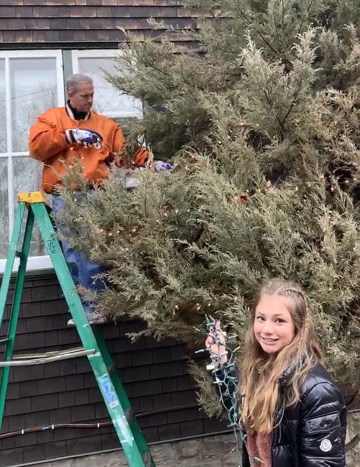 Coach Arron Deck and Emmie Deck assist with decorations at Conrad Mansion.
