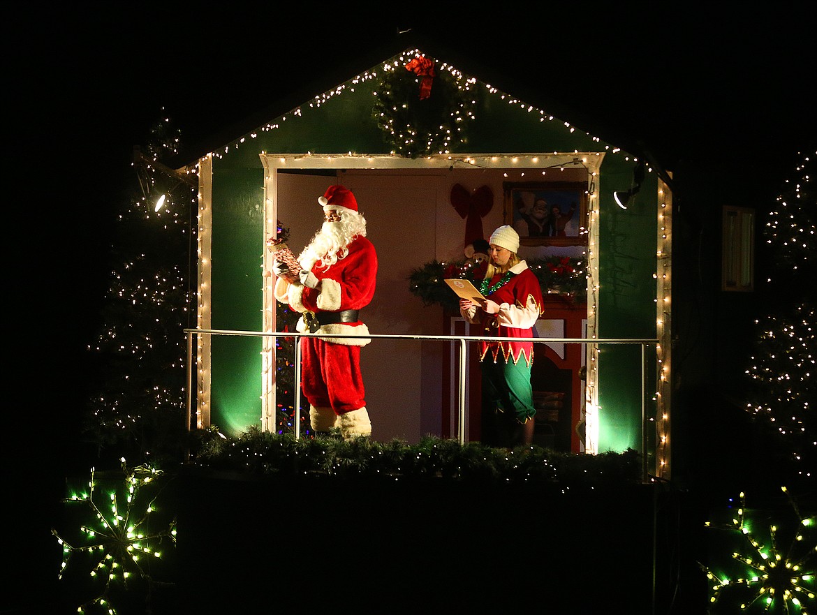 Santa reads the Nice List for guests during a Journey to the North Pole cruise Tuesday night. (LOREN BENOIT/Press)