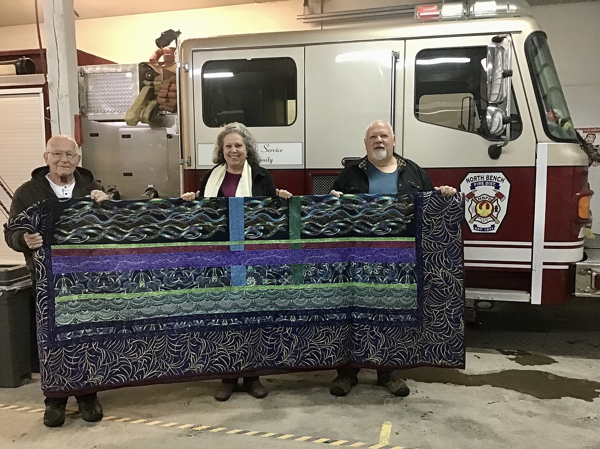 Courtesy photos
Quilt winner of the North Bench Volunteer Fire District Raffle. NBVFD board members Walter Burrow, left, and Earl Metier flank winner Merv Ashby.