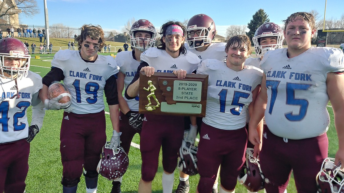 Senior class members of the Clark Fork Mountain Cats football team display the silver trophy after Saturday&#146;s state title game against Fairview. See stories and photos on A4 and A5. (Chuck Bandel/Mineral Independent)
