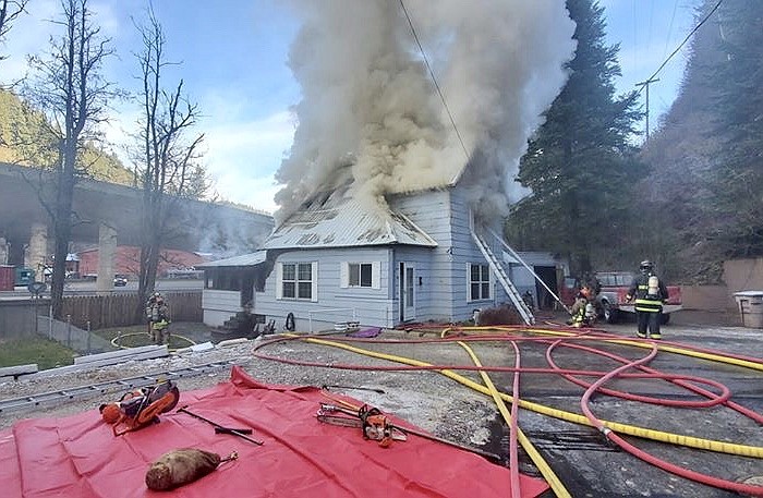 Hose lines circle the house as firefighters hit the blaze from every angle.