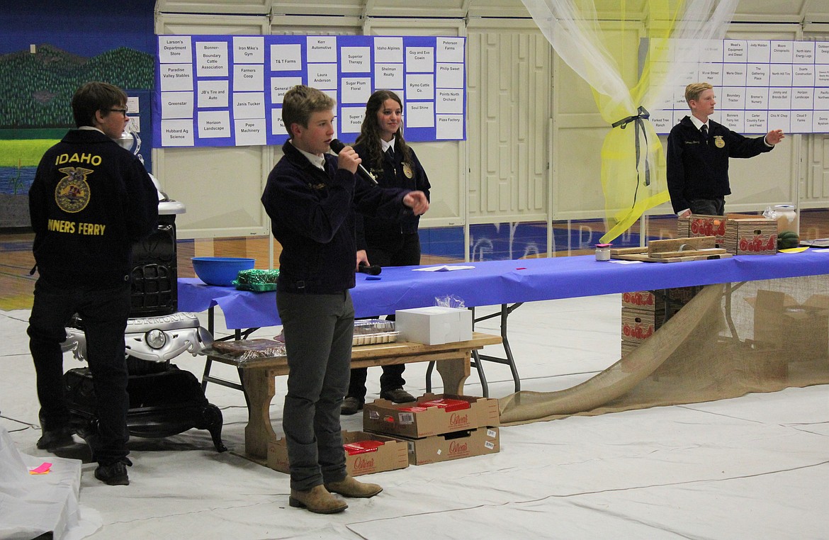 Photo by TONIA BROOKS
The event was led by the FFA members. Auctioneering during this time is Evan Nesbit while, from left to right, Jacob Bremer,  Rikki Cowin, and Brycen Cowin help with identifying bidders in the crowd.