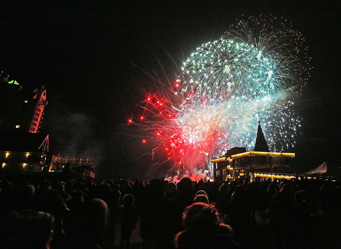 Spectators watch fireworks erupt in the sky above Lake Coeur d&#146;Alene during The Coeur d&#146;Alene Resort Holiday Light Show fireworks display on Friday.