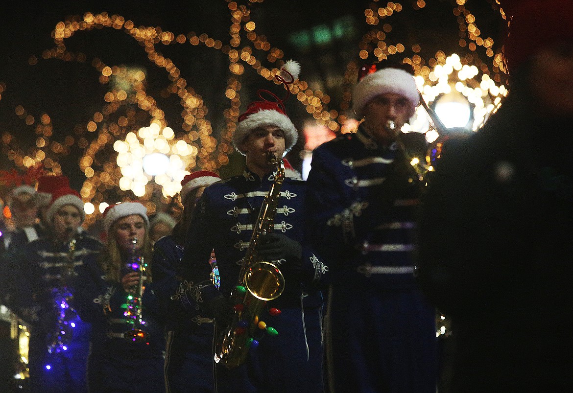 Mason Groth plays a holiday tune with the Coeur d'Alene Marching Band during the Holiday Light Show Parade on Friday. (LOREN BENOIT/Press)