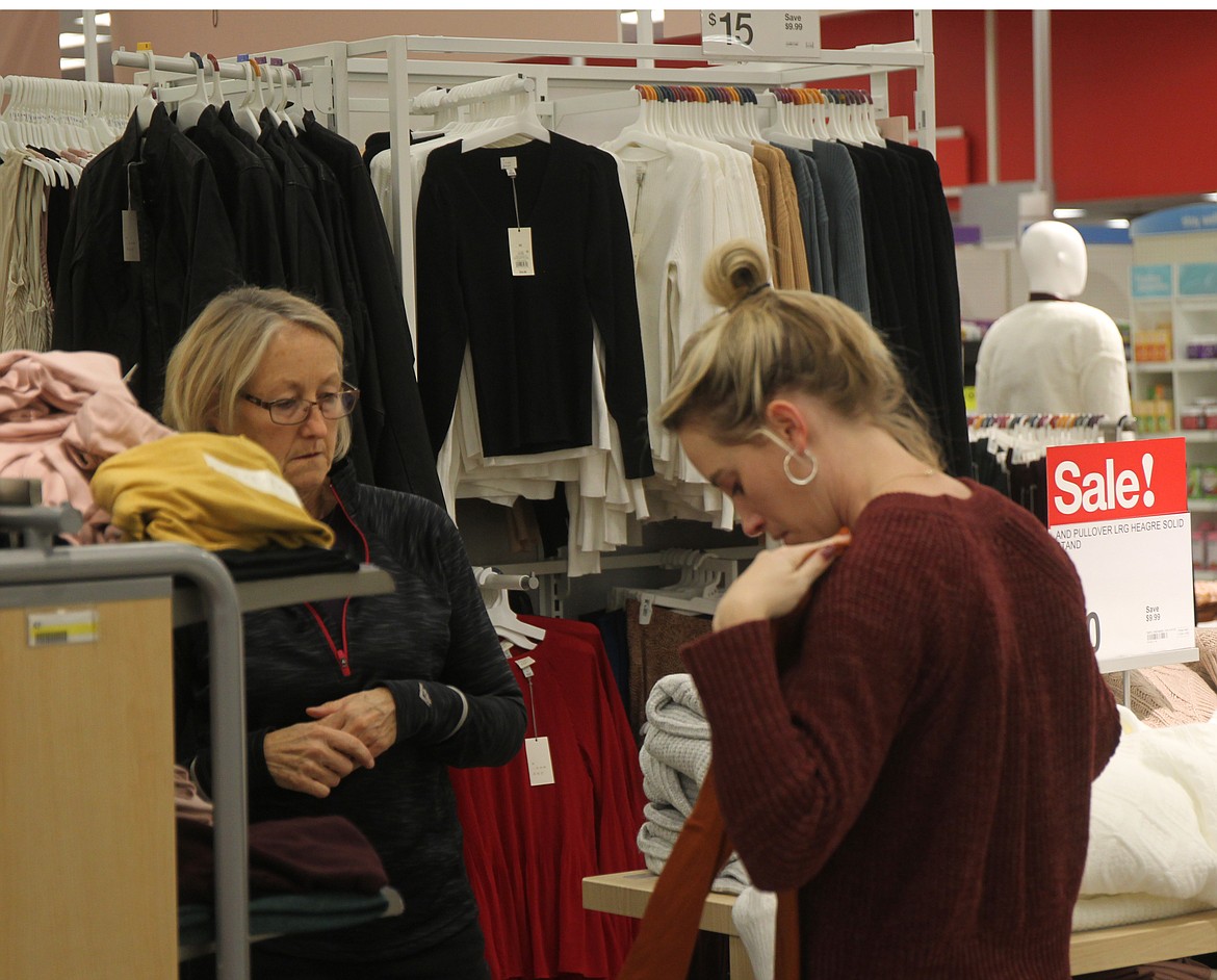 CRAIG NORTHRUP/Press
Lindsey Tompkins Messerly (right) showcases a shirt for Jill Tompkins to judge at the Coeur d&#146;Alene Target Friday morning. Despite a record $4.2 billion spent by online shoppers Thursday, a strong economy is boosting healthy crowds at brick-and-mortar parking lots from State Line to Sherman Avenue &#151; and around the country &#151; for this year&#146;s Black Friday shopping.