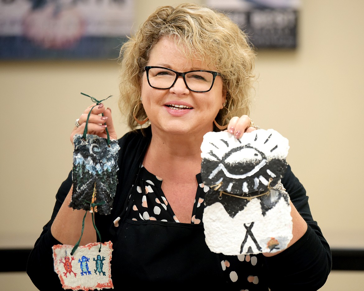 Special Education teacher Laurie Lutgen with some of the artwork created by students in an Indian Education For All project at Cayuse Prairie School.