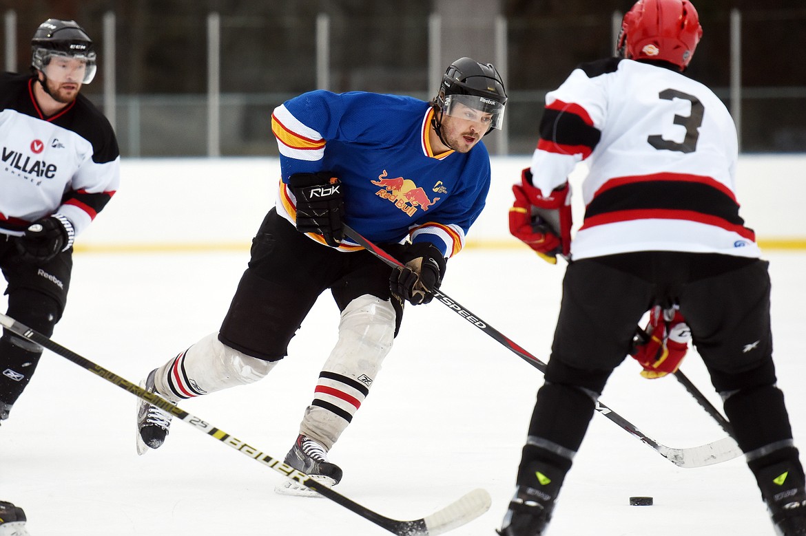 Kyle Archer, of the Fun Beverage team from Kalispell, works the puck up the ice against Village Brewery during the Craft Brewers Cup at the Woodland Park Ice Center on Friday. The Craft Brewers Cup is the largest fundraiser of the year for the Flathead Valley Hockey Association. The tournament continues Saturday with games starting at 7 a.m. along with a brewfest from noon to 8 p.m. Seven local breweries will be in attendance Saturday with nearly 20 beers on tap.  (Casey Kreider/Daily Inter Lake)