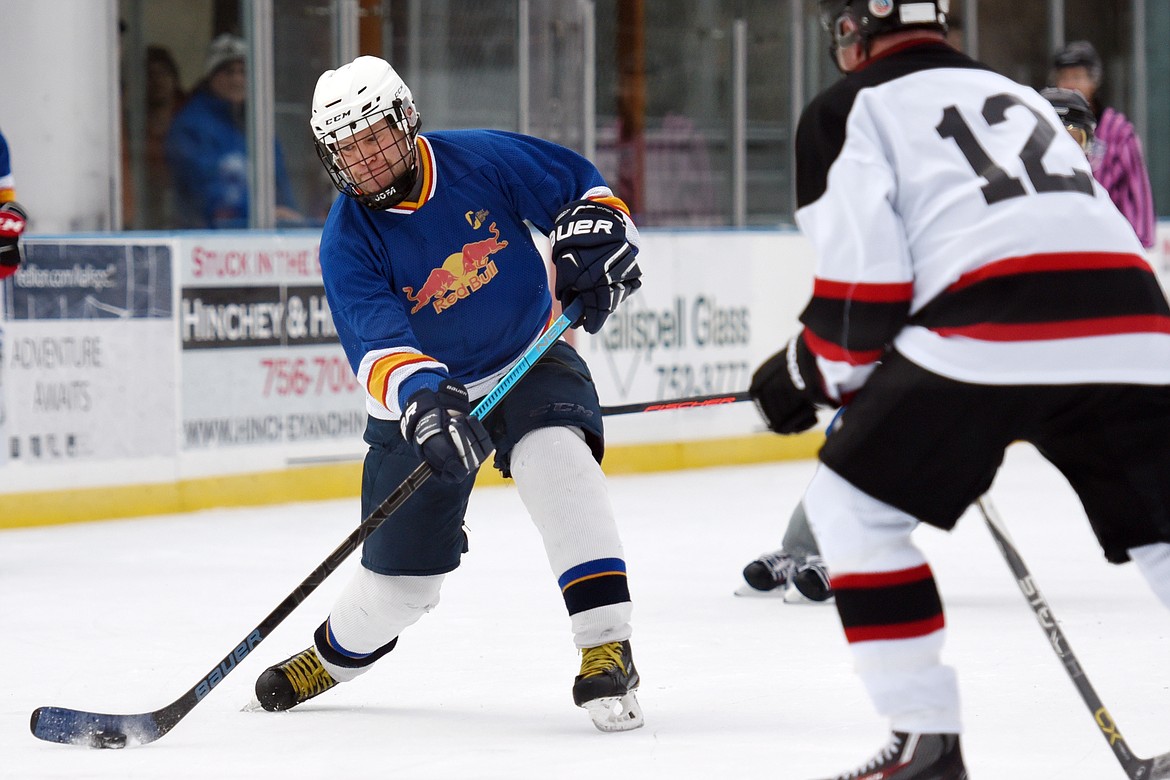 Neal Buffington, of the Fun Beverage team from Kalispell, shoots against Village Brewery during the Craft Brewers Cup at the Woodland Park Ice Center on Friday. The Craft Brewers Cup is the largest fundraiser of the year for the Flathead Valley Hockey Association. The tournament continues Saturday with games starting at 7 a.m. along with a brewfest from noon to 8 p.m. Seven local breweries will be in attendance Saturday with nearly 20 beers on tap.  (Casey Kreider/Daily Inter Lake)