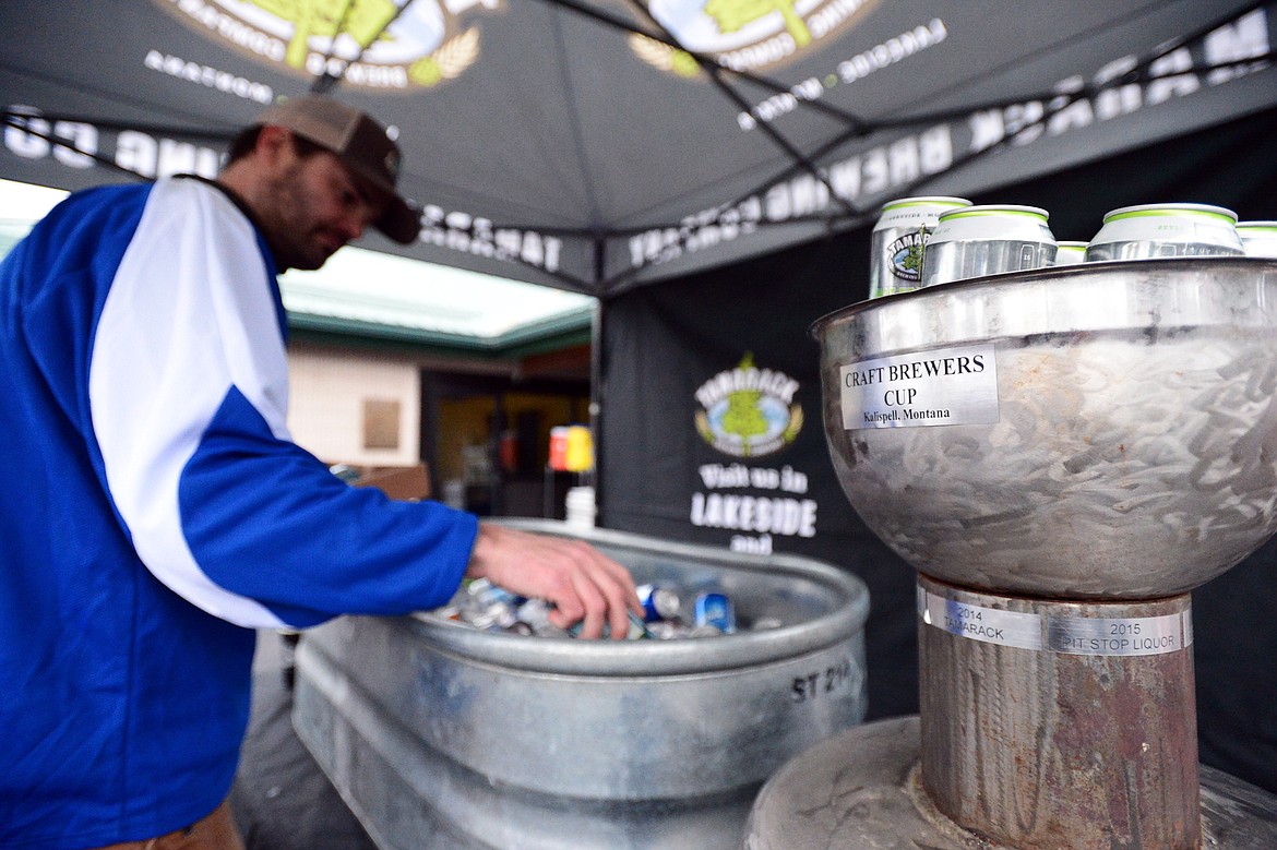 Keith Ridgway, coach of the Fun Beverage team and an organizer of the Craft Brewers Cup, puts a selection of beer on ice next to the championship trophy during a break in play against Village Brewery at the Woodland Park Ice Center on Friday. Fun Beverage beat Village Brewery, 5-4. The Craft Brewers Cup is the largest fundraiser of the year for the Flathead Valley Hockey Association. The tournament continues Saturday with games starting at 7 a.m. along with a brewfest from noon to 8 p.m. Seven local breweries will be in attendance Saturday with nearly 20 beers on tap.  (Casey Kreider/Daily Inter Lake)