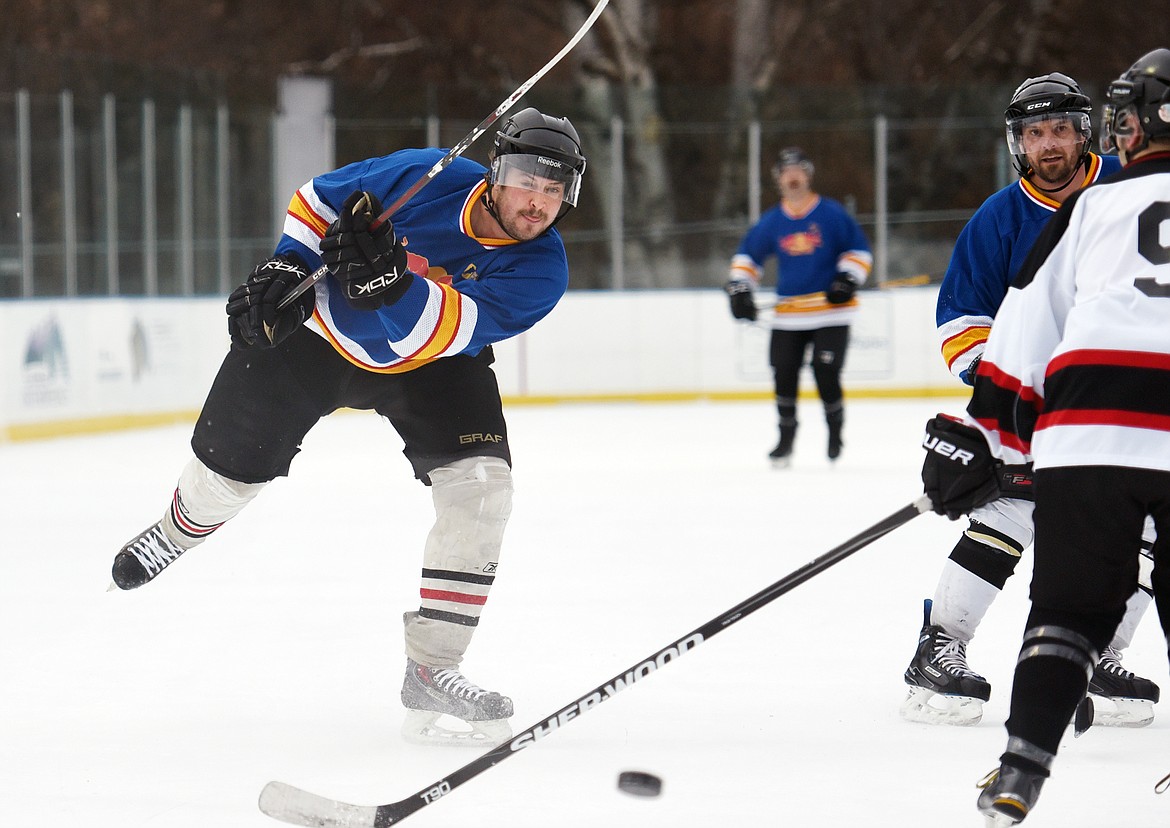 Kyle Archer, of the Fun Beverage team from Kalispell, shoots against Village Brewery during the Craft Brewers Cup at the Woodland Park Ice Center on Friday. The Craft Brewers Cup is the largest fundraiser of the year for the Flathead Valley Hockey Association. The tournament continues Saturday with games starting at 7 a.m. along with a brewfest from noon to 8 p.m. Seven local breweries will be in attendance Saturday with nearly 20 beers on tap.  (Casey Kreider/Daily Inter Lake)