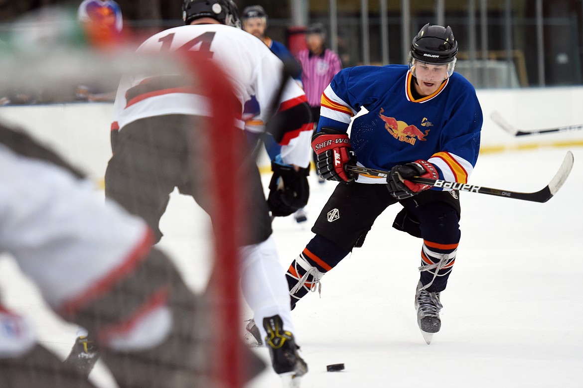 Jake Topp, of the Fun Beverage team from Kalispell, works the puck into the Village Brewery zone during the Craft Brewers Cup at the Woodland Park Ice Center on Friday. The Craft Brewers Cup is the largest fundraiser of the year for the Flathead Valley Hockey Association. The tournament continues Saturday with games starting at 7 a.m. along with a brewfest from noon to 8 p.m. Seven local breweries will be in attendance Saturday with nearly 20 beers on tap.  (Casey Kreider/Daily Inter Lake)