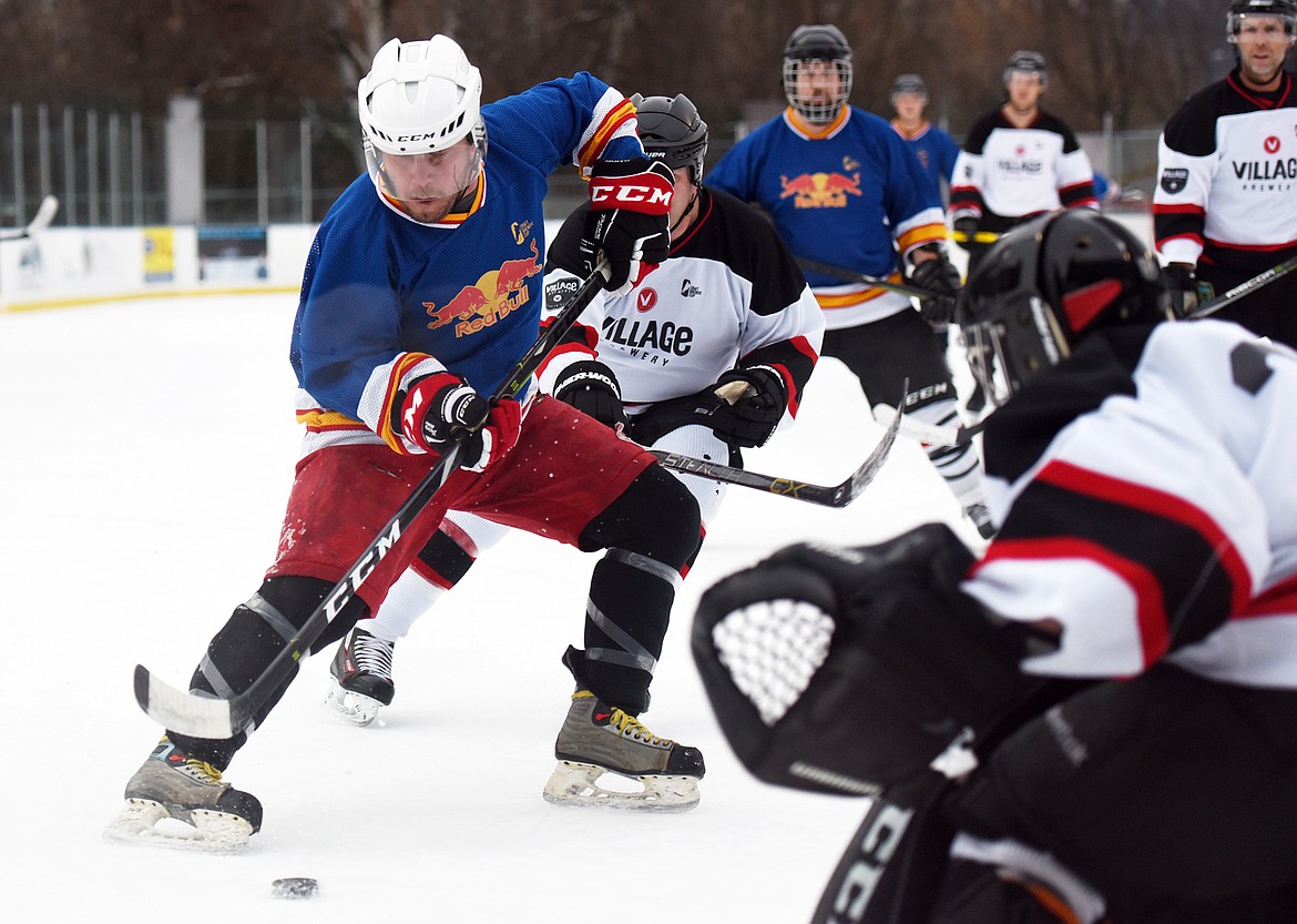 Kurt Barnett, of the Fun Beverage team from Kalispell, looks to shoot against Village Brewery during the Craft Brewers Cup at the Woodland Park Ice Center on Friday. The Craft Brewers Cup is the largest fundraiser of the year for the Flathead Valley Hockey Association. The tournament continues Saturday with games starting at 7 a.m. along with a brewfest from noon to 8 p.m. Seven local breweries will be in attendance Saturday with nearly 20 beers on tap.  (Casey Kreider/Daily Inter Lake)