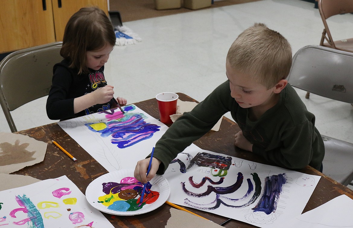 (Photo by MARY MALONE)
As the school day came to an end on Nov. 21, more than 20 Idaho Hill Elementary students stayed for a long-standing monthly tradition &#151; the After School Art program. The November theme was &#147;Snowy Night,&#148; so before getting started, the students closed their eyes and listened to a poem read by Renee Gamber, a paraprofessional at Idaho Hill and volunteer instructor for the After School Art program. The poem she read was about a person in the woods, near a frozen lake, alone with a little horse. It was snowing on the darkest night of the year. The students were instructed to picture the scene, then do a quick pencil sketch before adding color to their art with paint. Each student pictured the scene a bit different, as some saw the dark night as pitch black, while others saw it as a dark gray or shades of dark red, black and purple. The horse sometimes had spots, the frozen lake was sometimes blue, sometimes turquoise. Each work of art was, of course, unique.