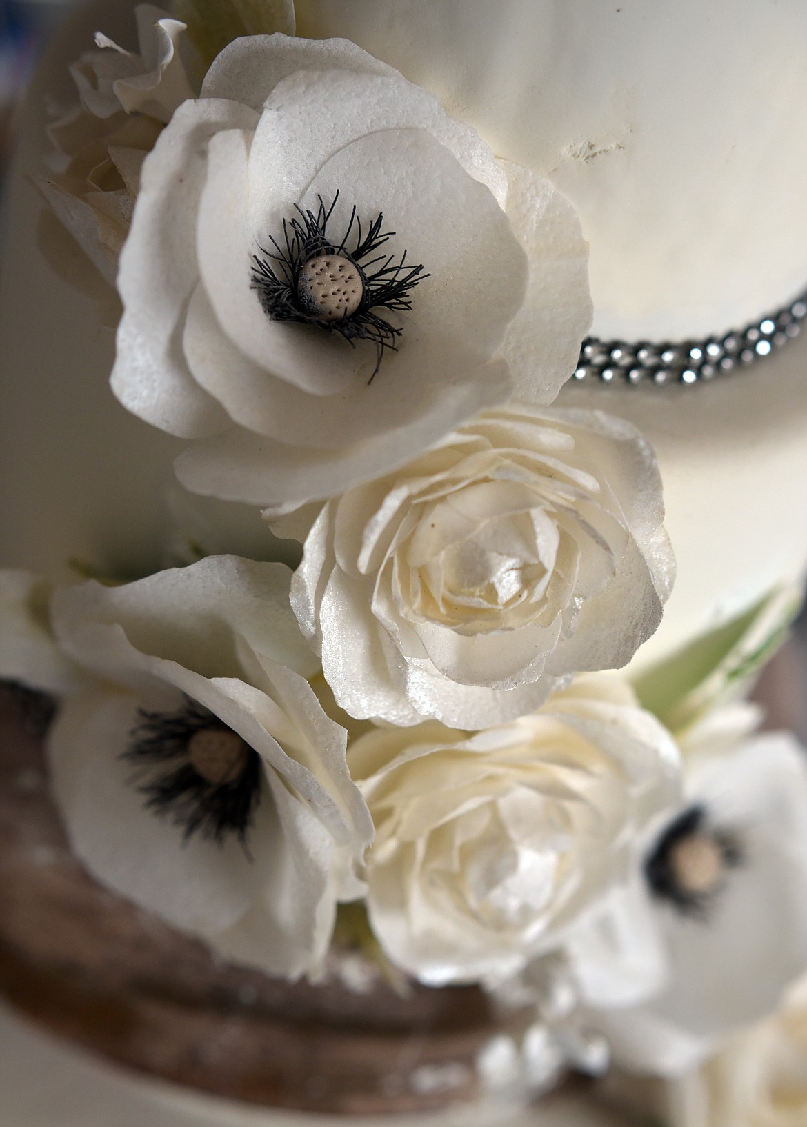 A display cake by Debi Hanscom of Cakes by Debi with handmade edible wafer paper flowers.