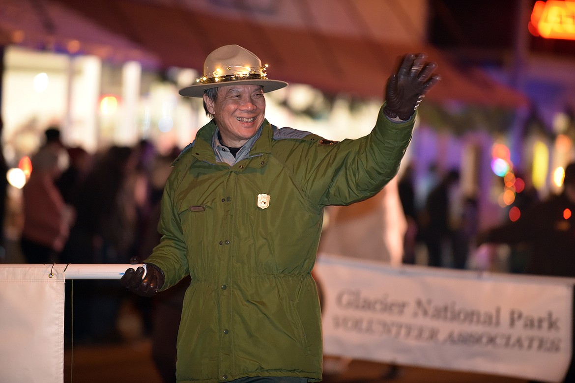 Glacier National Park Superintendent Jeff Mow waves to the crowd during the Night of Lights Parade Friday. (Jeremy Weber photo)