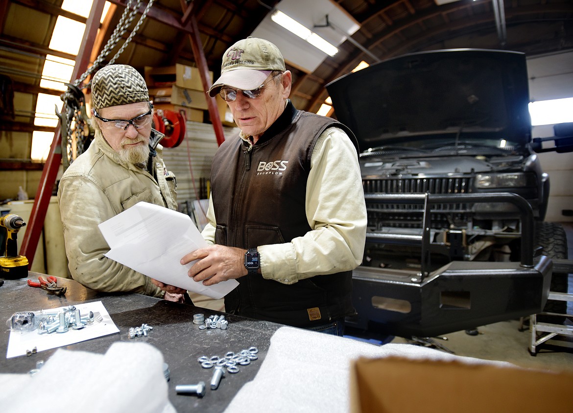 Art Walle, left, and Tom Currier, add a Buckstop bumper to a truck at Currier&#146;s Certified Welding.