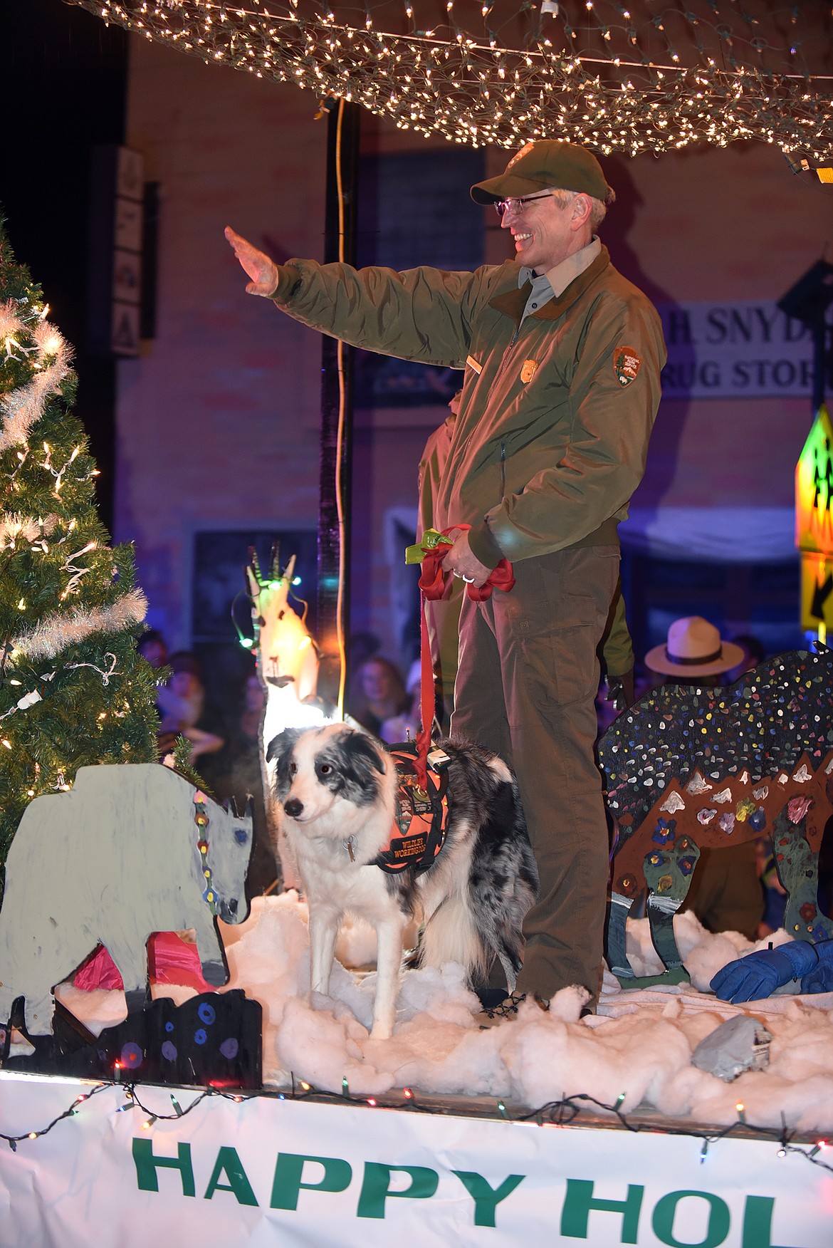 Park Ranger Mark Biel and Bark Ranger Gracie ride the Glacier National Park float. (Jeremy Weber photo)