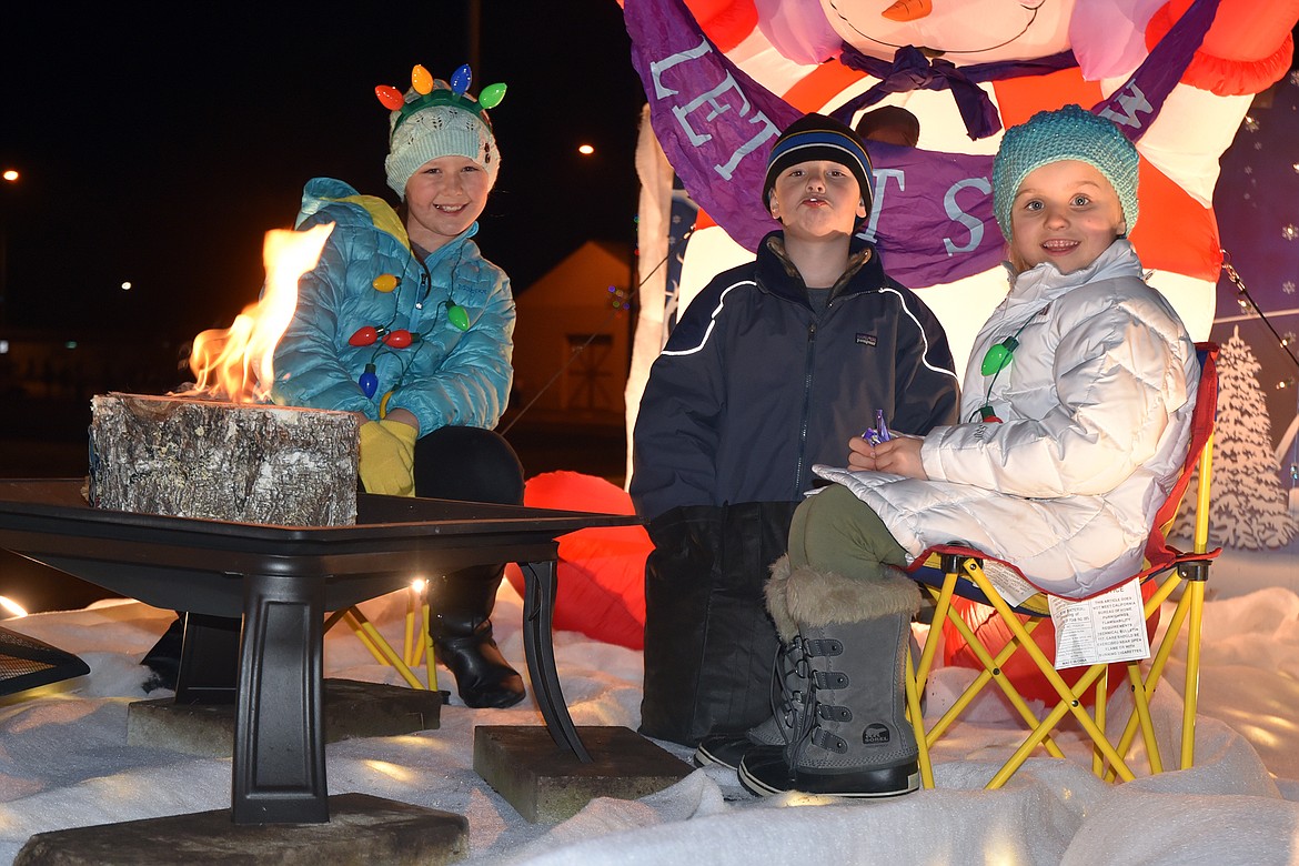 Kassidy Lingle, Ezra Taylor and Kenly Piilola hanging out on the Glacier Bank float. (Jeremy Weber photo)