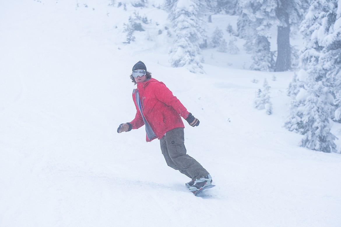 A snowboarder makes a turn on Whitetail during opening day. (Daniel McKay/Whitefish Pilot)